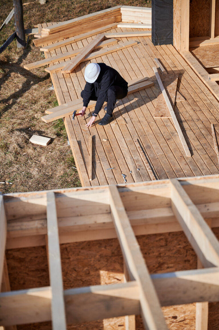 Construction worker working on a home addition and adding a room